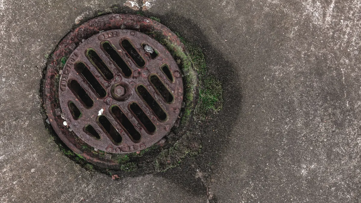 round storm drain grate in pavement