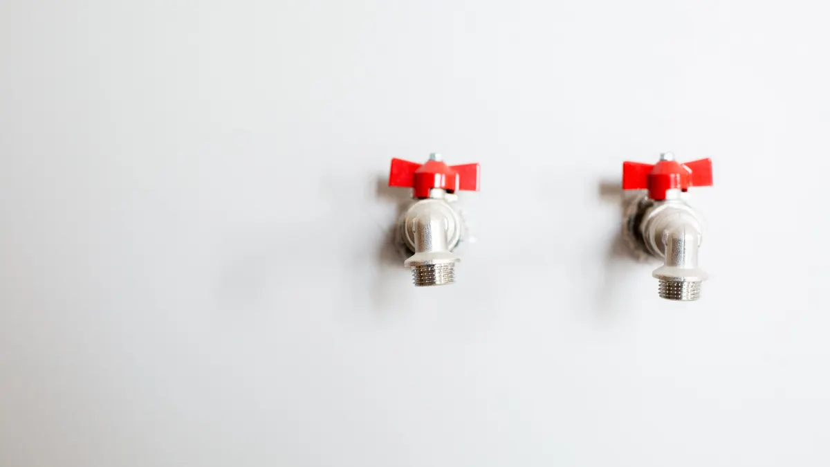 Emergency Plumber: What to Do Before the Plumber Arrives Two small shutoff valves on a white wall