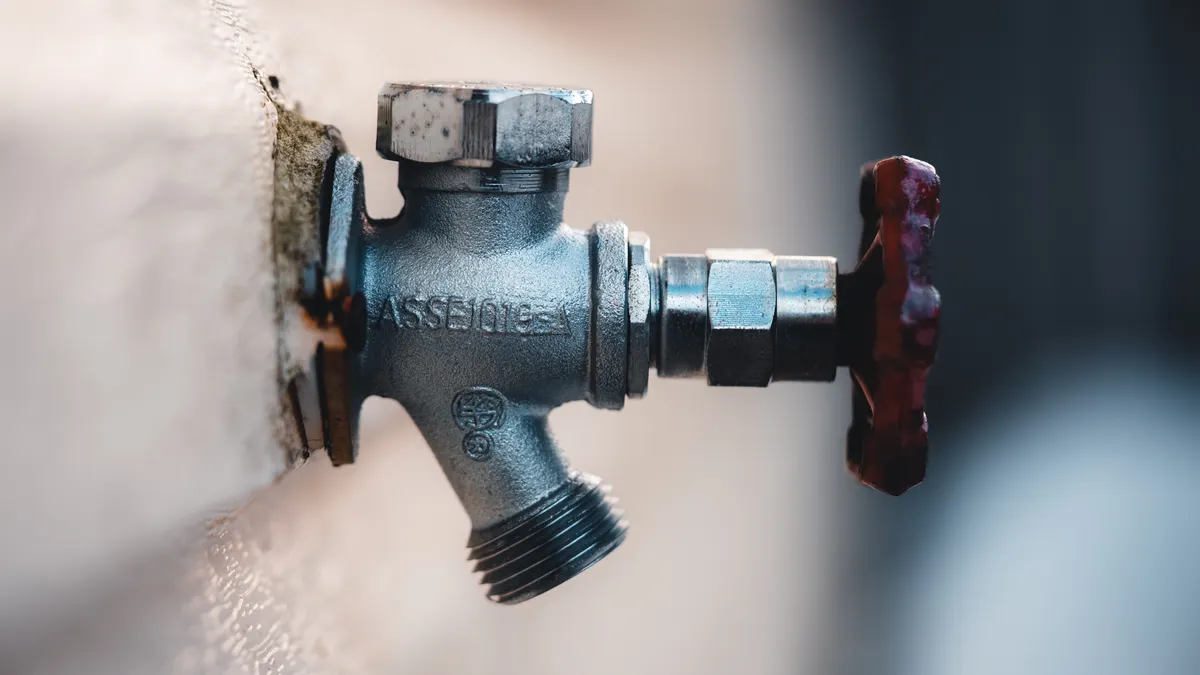 Wall-mounted water shutoff valve on a pipe