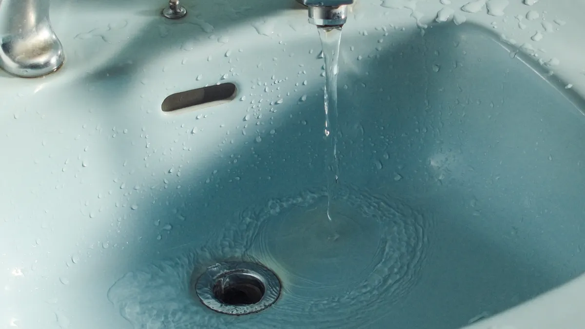 How to Unclog a Sink Drain Safely Bathroom sink with water draining